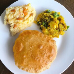 4 Puri with halwa or puri with rock salted potato fry.